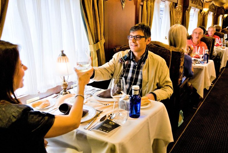 Guests toasting over dinner aboard the Costa Verde Express