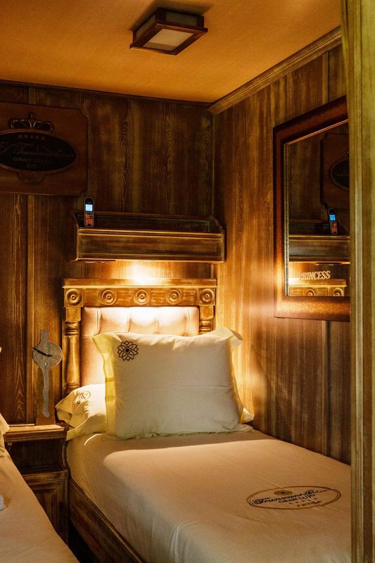Bedside detail in a Gran Lujo suite with reading lights and wood panelling
